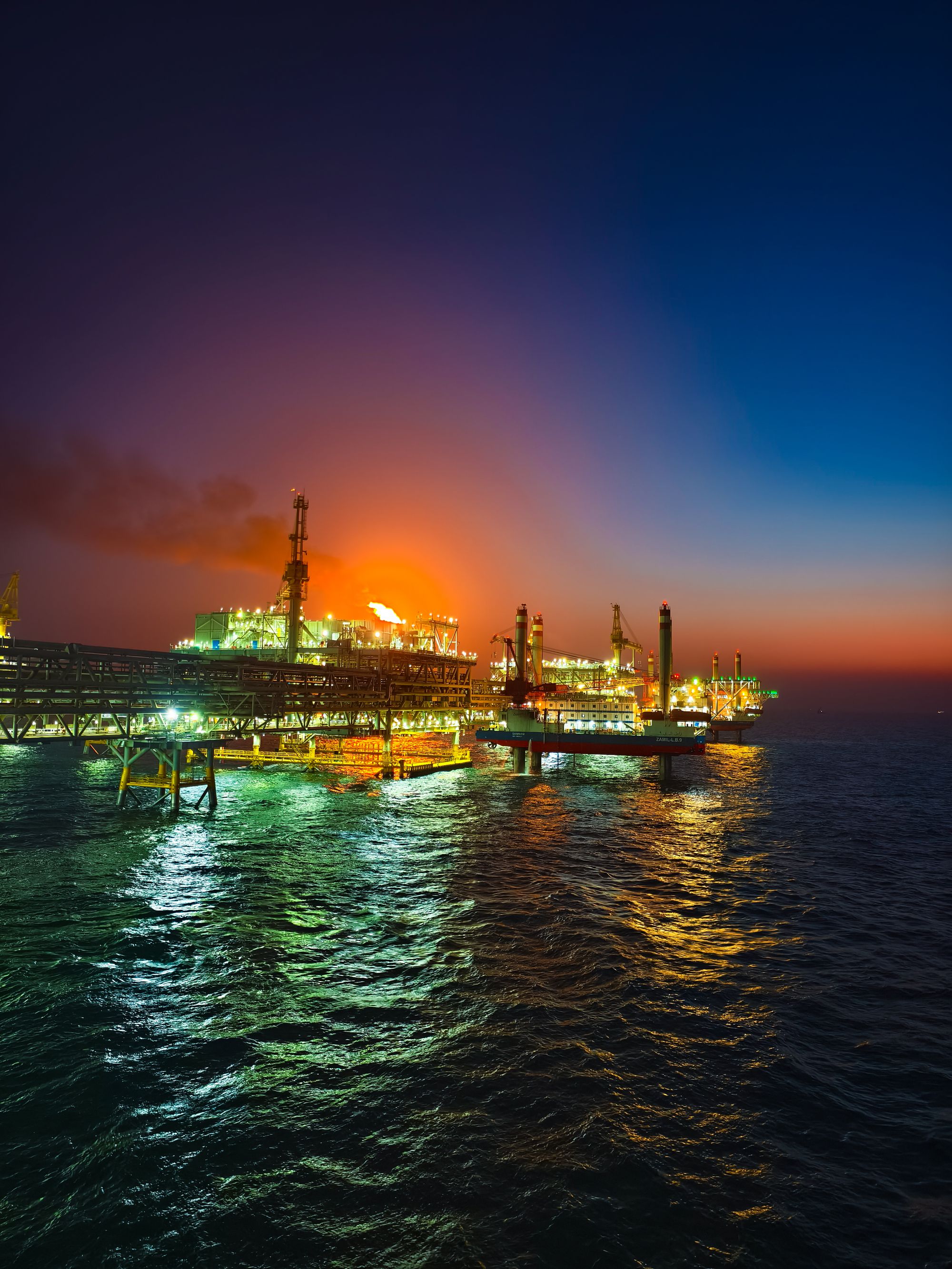 Offshore oil platform illuminated at night