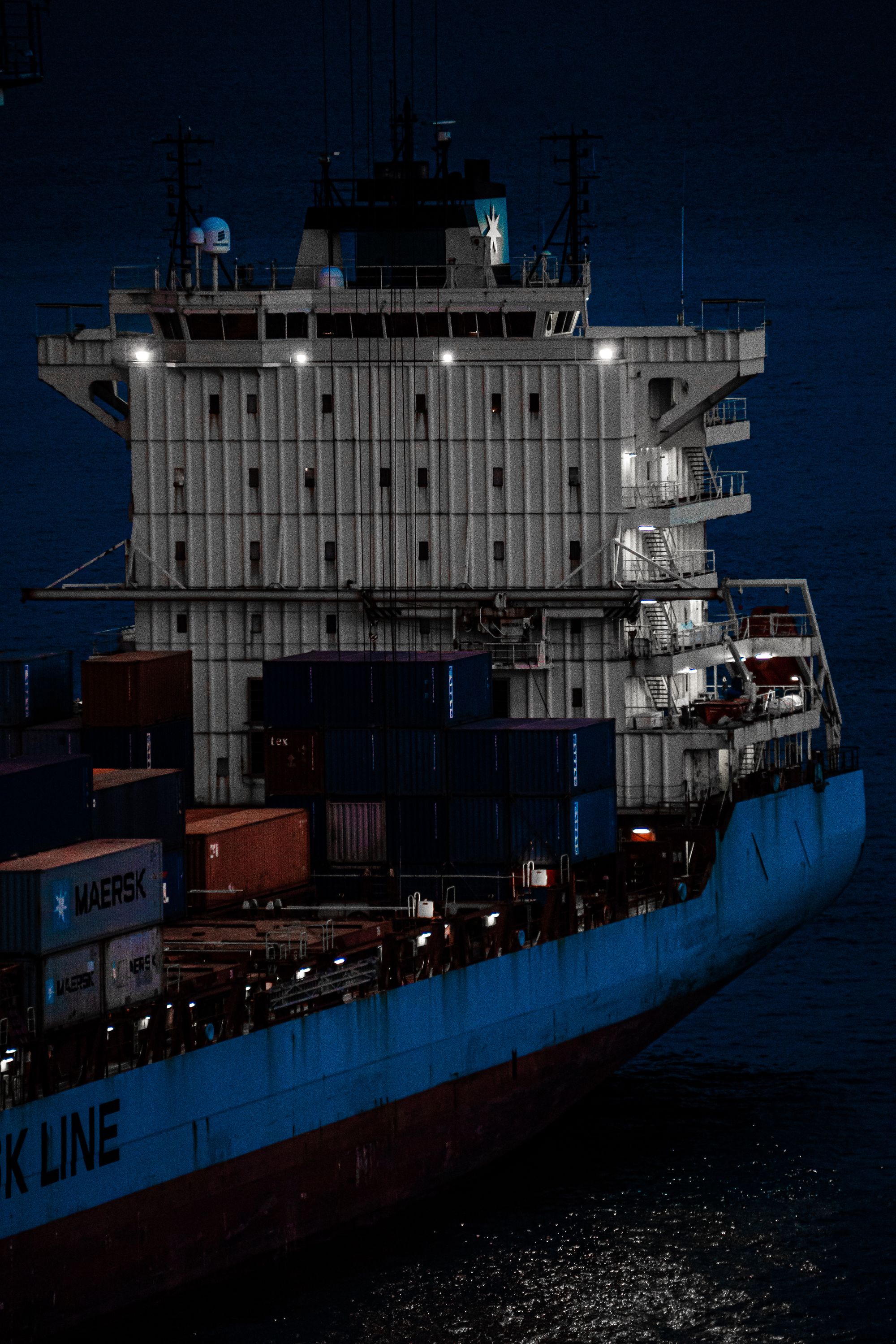 Stacked shipping containers aboard a vessel