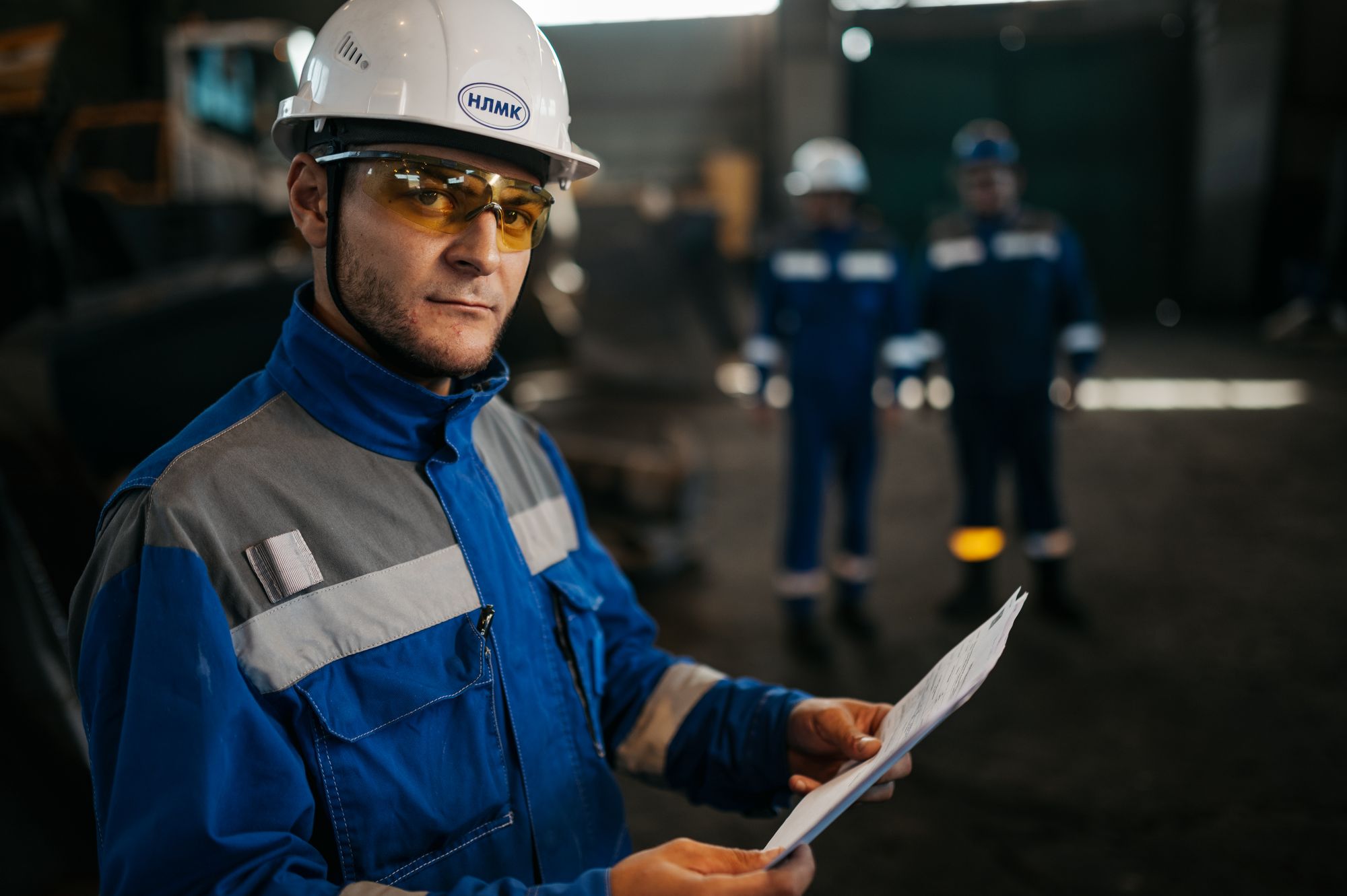 Engineer inspecting equipment with documentation